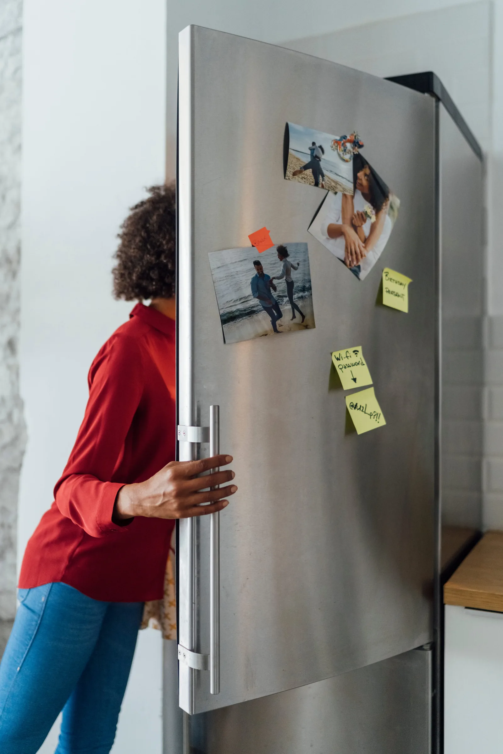 Homeowner taking fresh food from her fridge after the repair visit